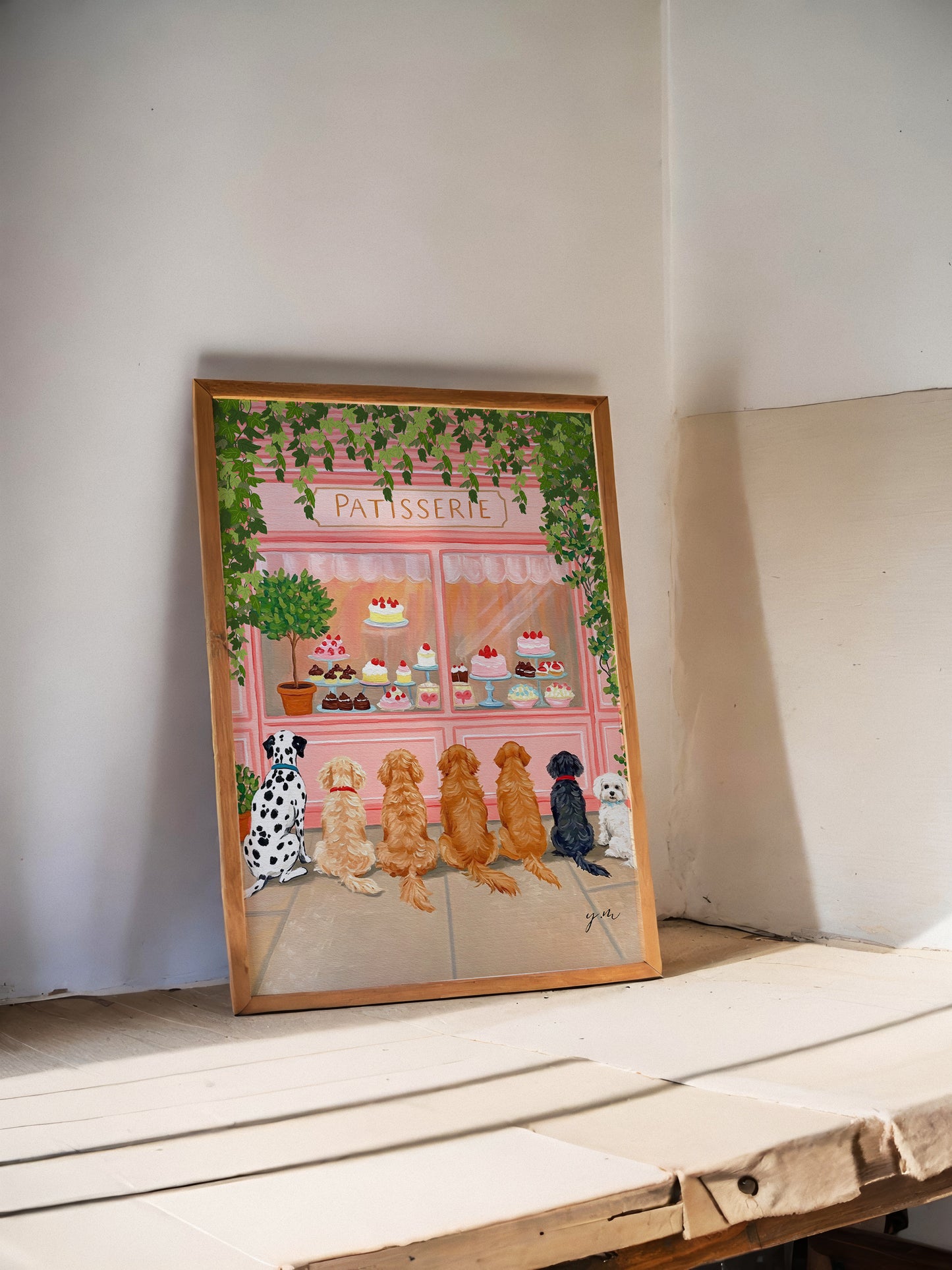 Adorable Puppies Sitting in a Row Waiting for Treats in Front of a Whimsical Pastry & Dessert Shop