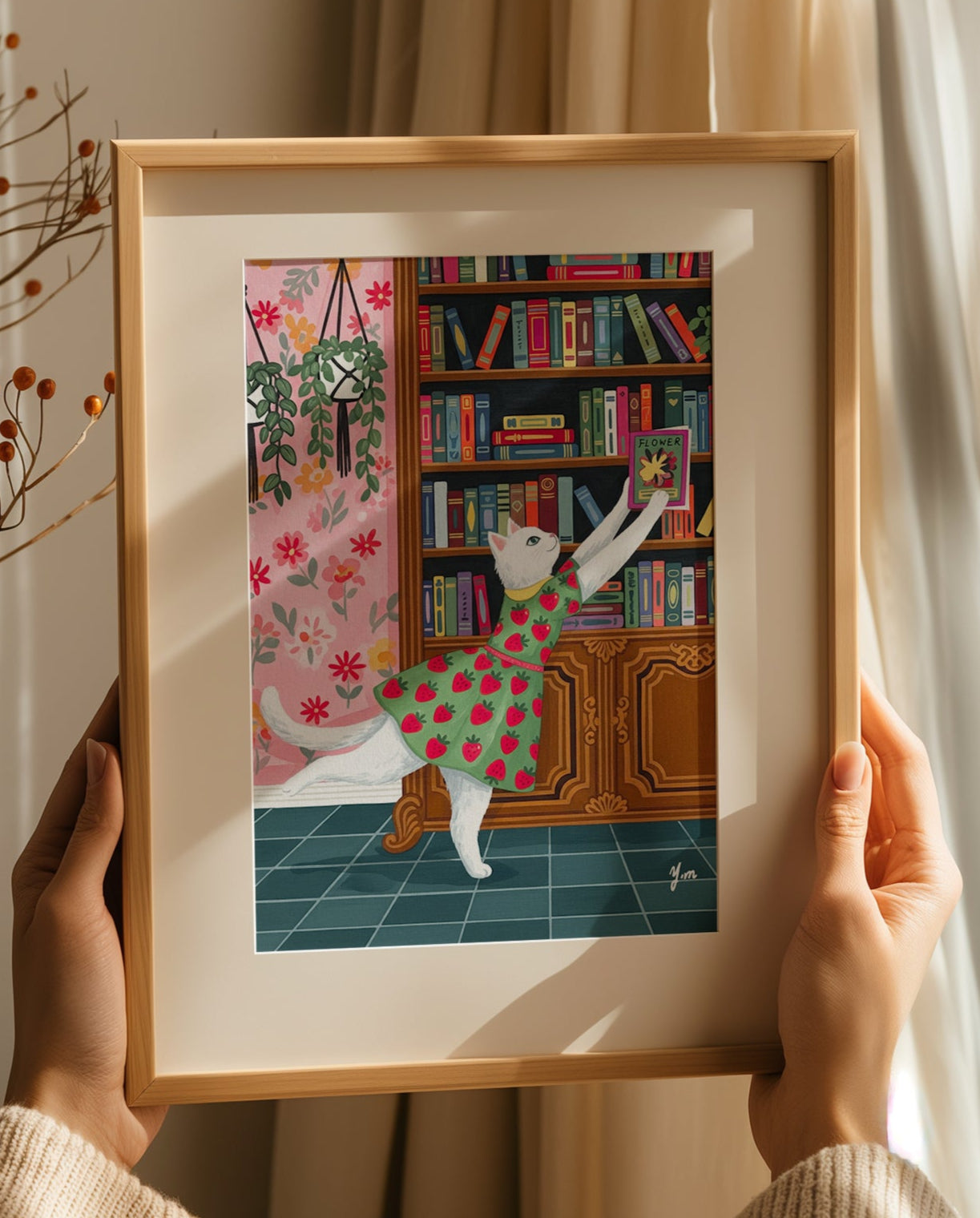 Whimsical illustration of a white cat in a strawberry dress reaching for a book in a vintage library with floral wallpaper, plants, and colorful books.

