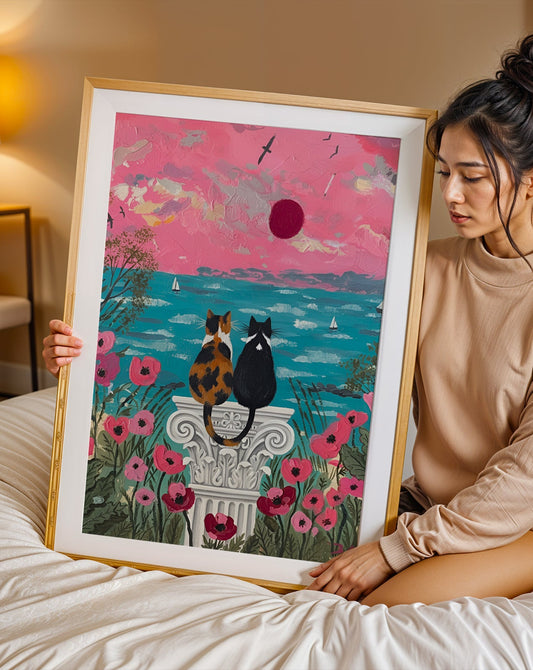 Romantic coastal cat artwork featuring two cats watching a pink seaside sunset surrounded by flowers. A dreamy cottagecore illustration for cat lovers and cozy home decor.