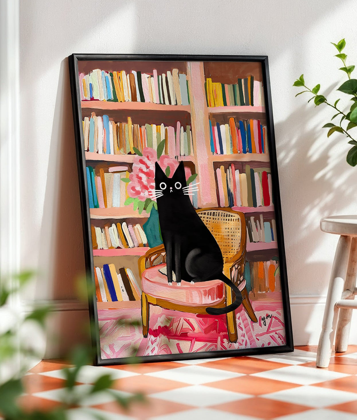 Black tuxedo cat sitting on a vintage pink chair in a cozy library with bookshelves and flowers — whimsical illustrated art print by YunaMoona